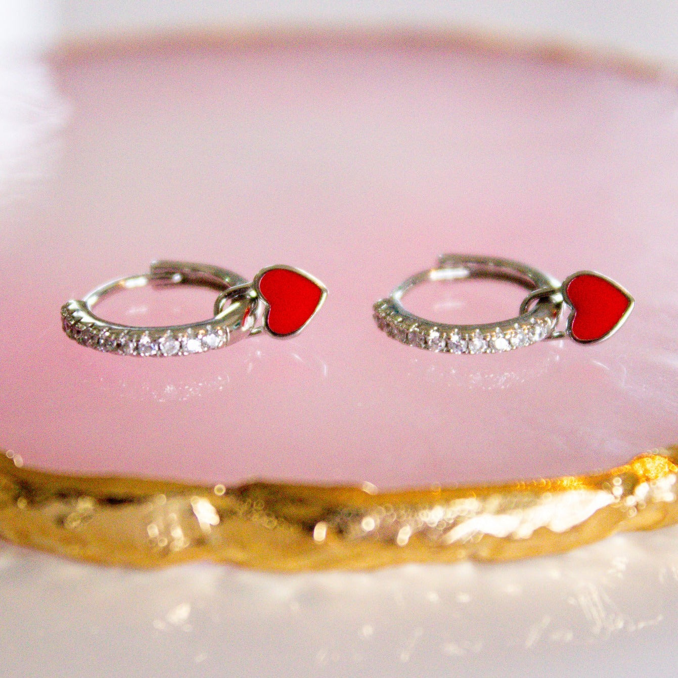 silver hoops with red heart charms