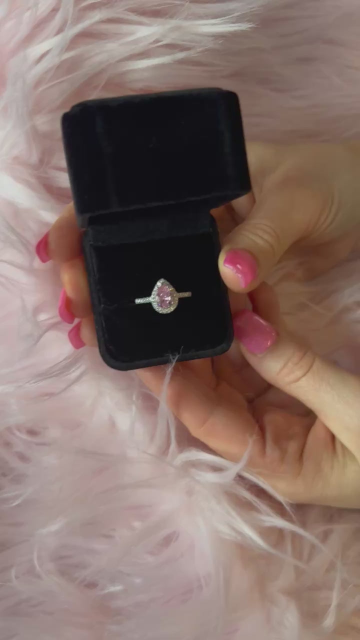 video of pink pear ring in a black velvet box