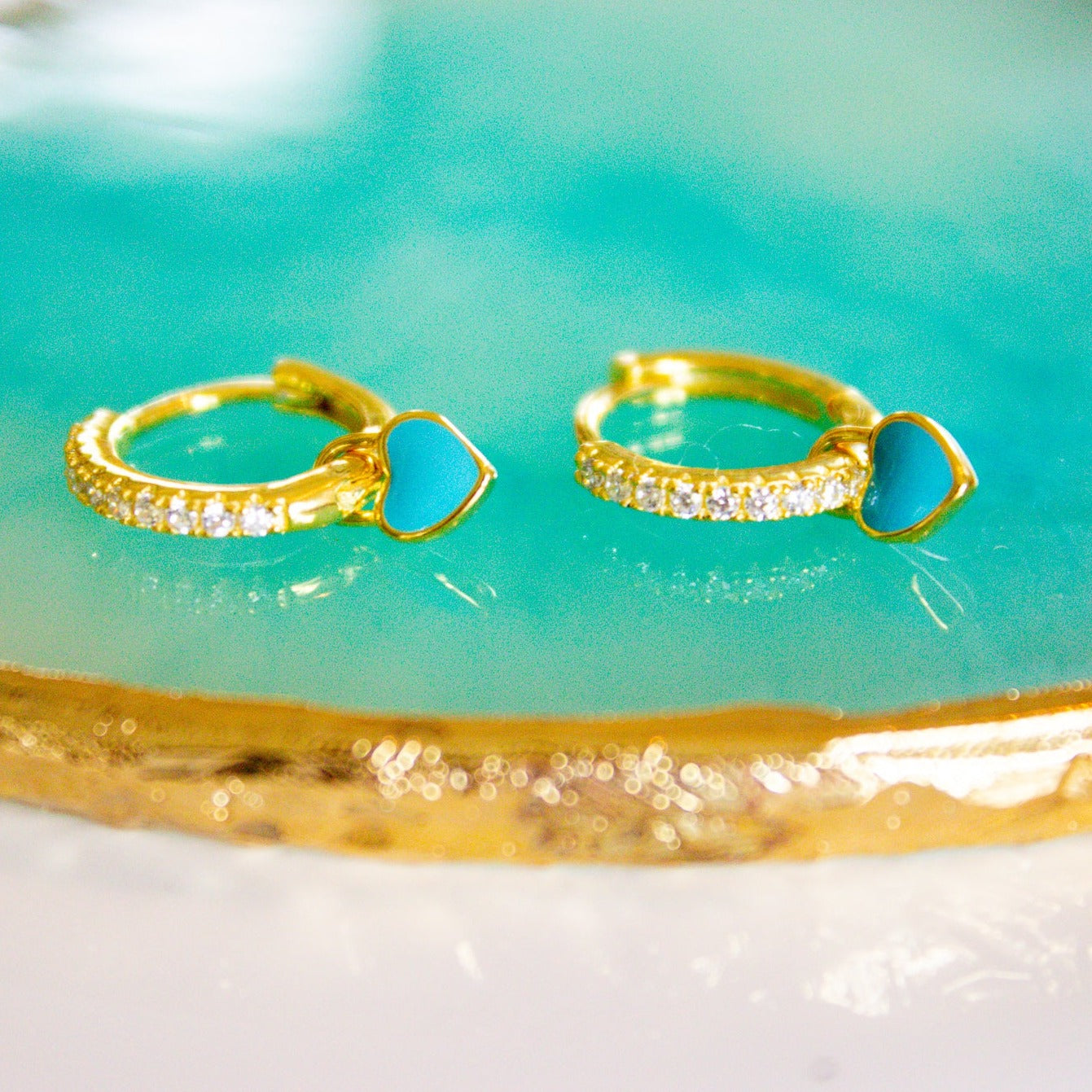 gold hoops with teal heart charms