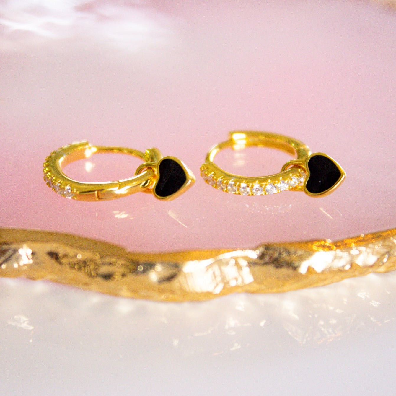gold hoops with black heart charms